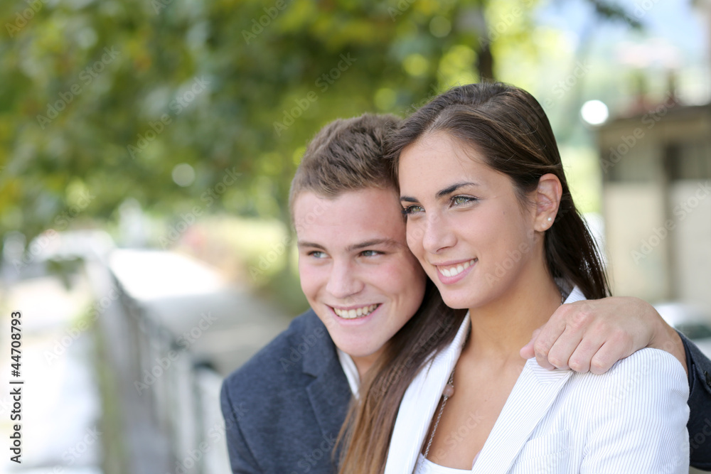 Cheerful young couple in town