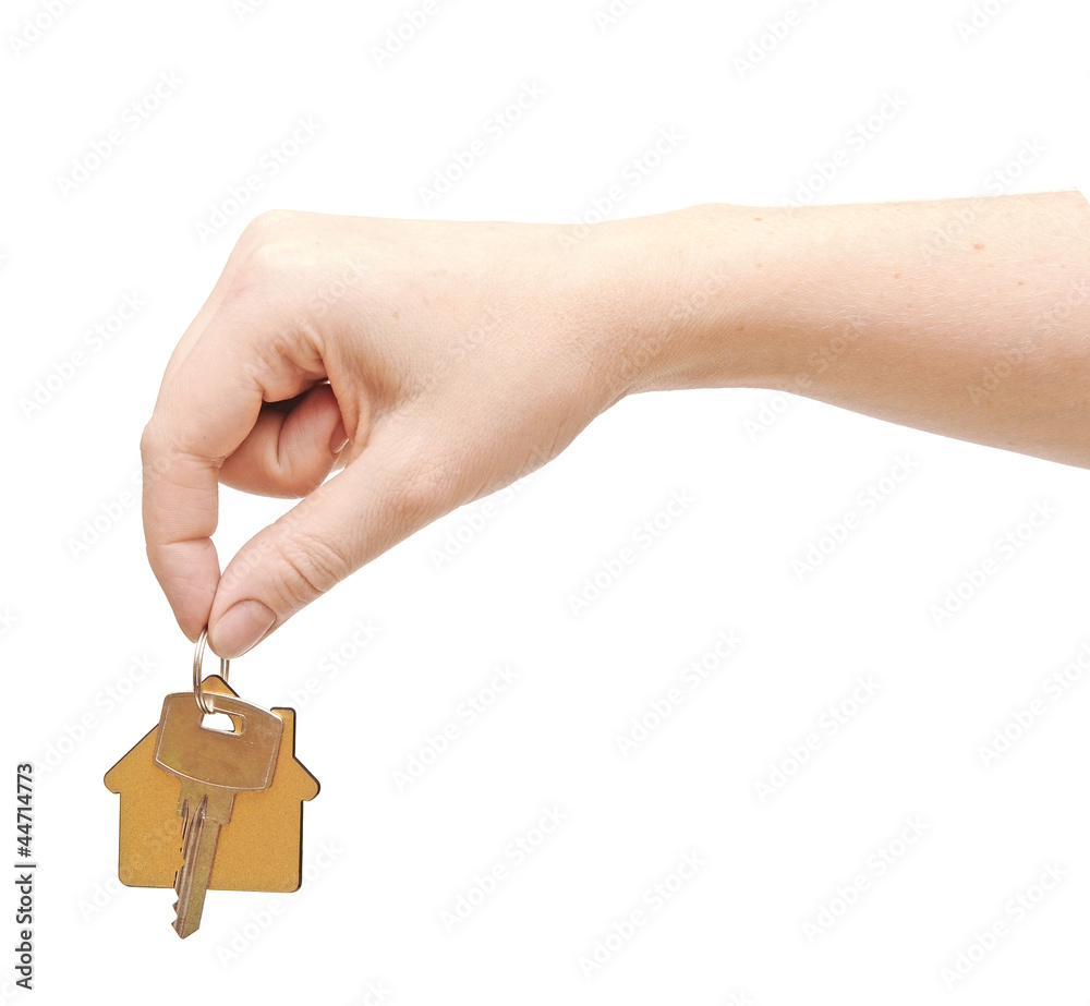 Obraz premium hand with chrome house key isolated on white