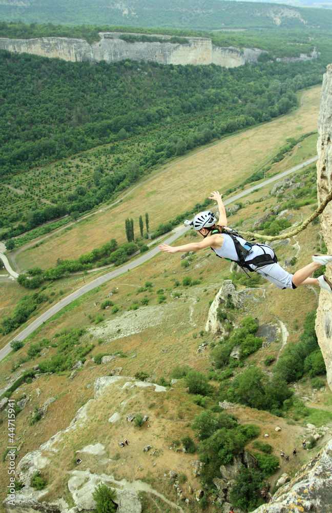 Obraz premium Jump off a cliff with a rope.