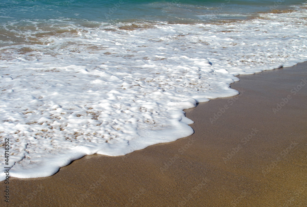 Waves breaking on shore
