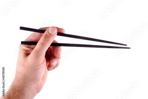man hand holding black japanese chopsticks