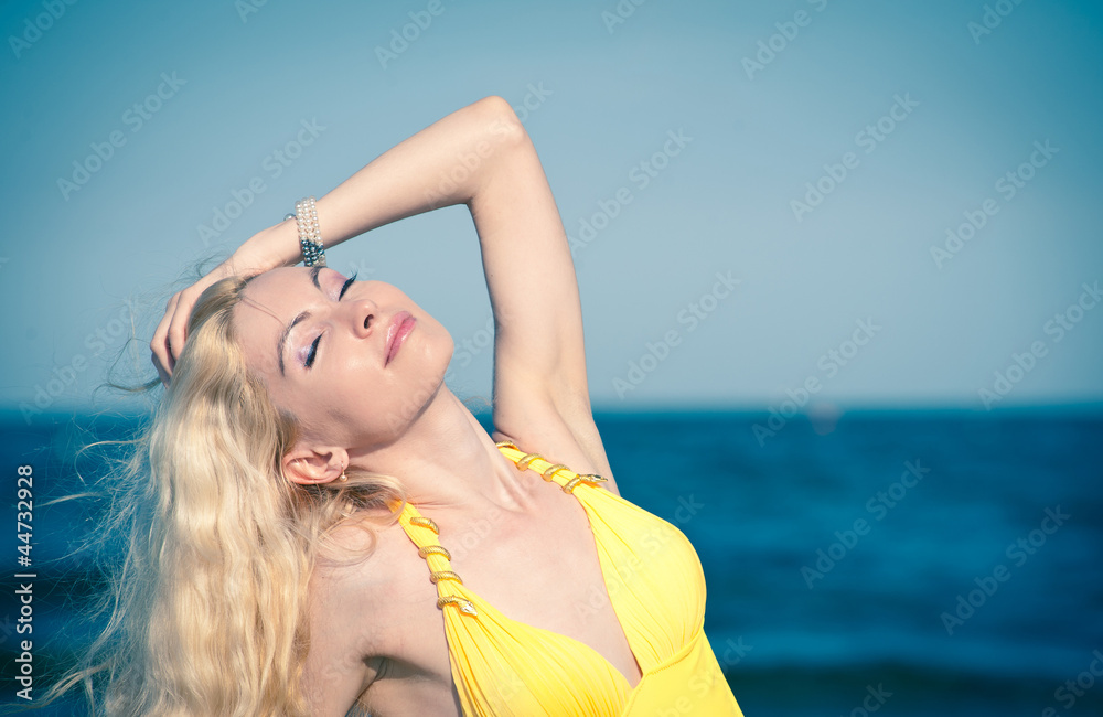 Beautiful young woman posing at the beach.