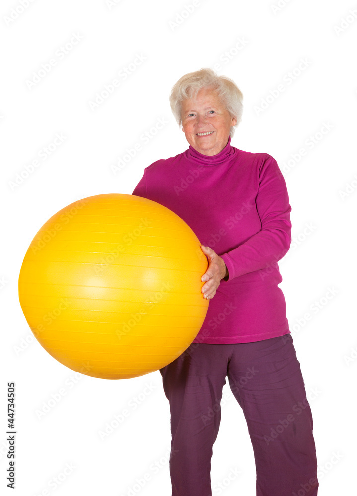 Happy retired woman holding gym ball Happy retired woman holding gym ball