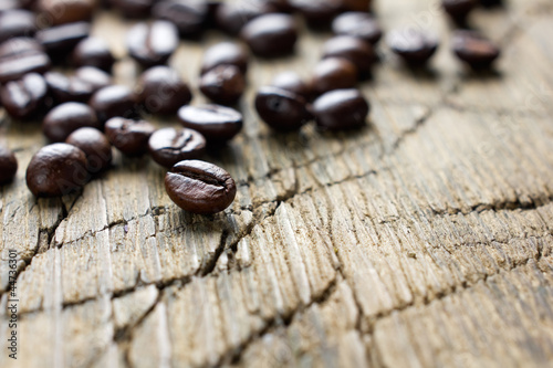 Coffee beans on the vintage wooden background