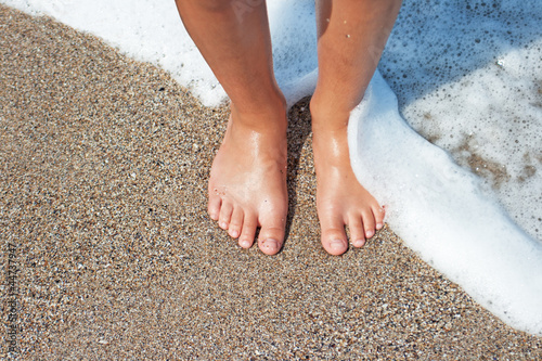 Feet of child on the beach