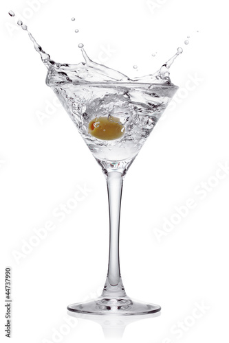 Splash from olive in a glass of cocktail.