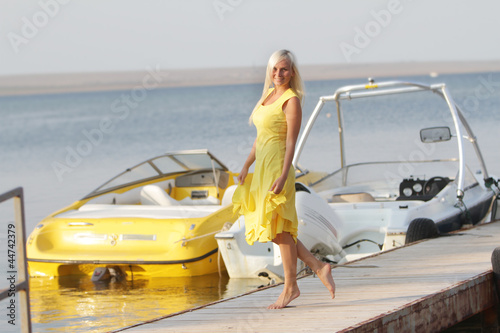 young happy woman on sea boats background