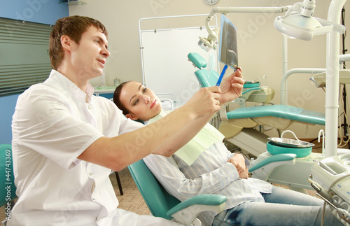 A dentist holding an x-ray