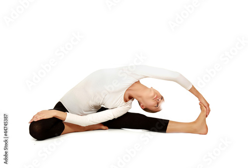 Gymnast girl in flexible back pose, isolated on white background
