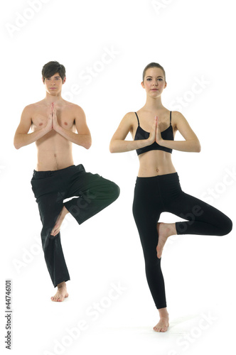 Couple (male / female) doing yoga exercises together balances