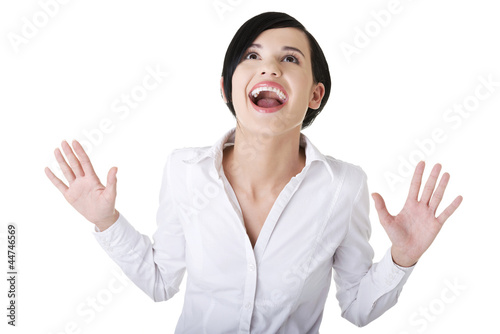 Portrait of surprised excited young business woman looking up
