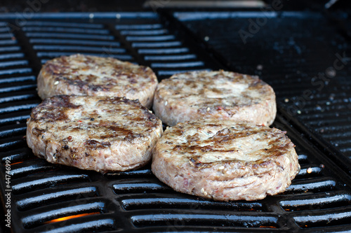 Beef quarterpounder burgers cooking on the gas barbecue