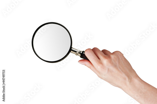 Magnifier glass in woman hand isolated on white