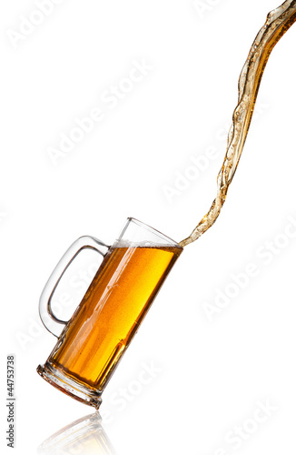 Pouring beer into glass, isolated on white background
