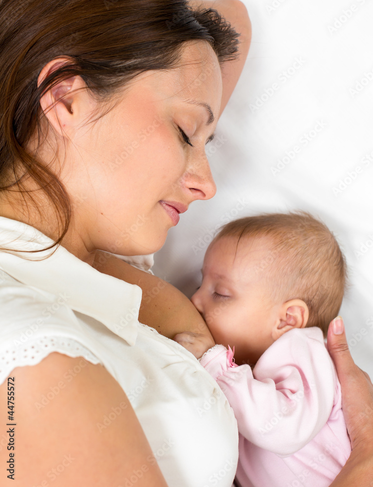 close-up portrait of mother breast feeding her baby infant close-up portrait of mother breast feeding her baby infant
