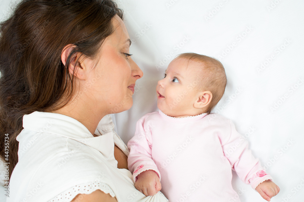 joyful mother playing with her baby infant joyful mother playing with her baby infant