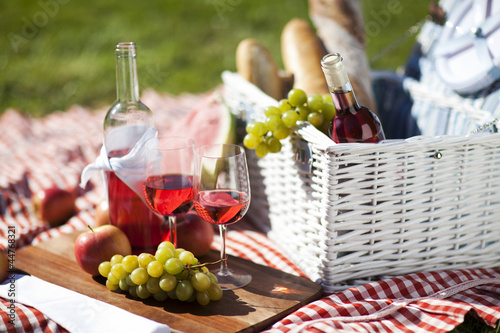 Fresh food from picninc basket on grass in the garden photo