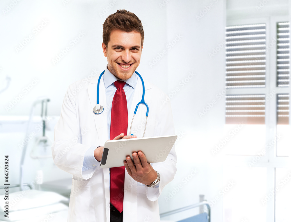 Handsome doctor using a tablet Handsome doctor using a tablet
