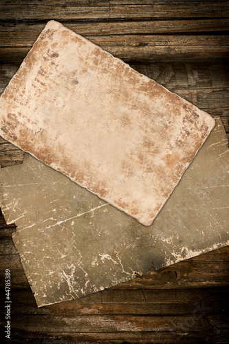 Faded old papers on a wooden background