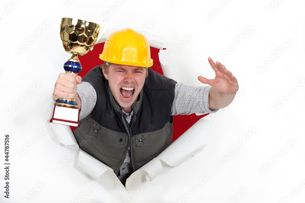 young craftsman holds trophy shouting for joy young craftsman holds trophy shouting for joy
