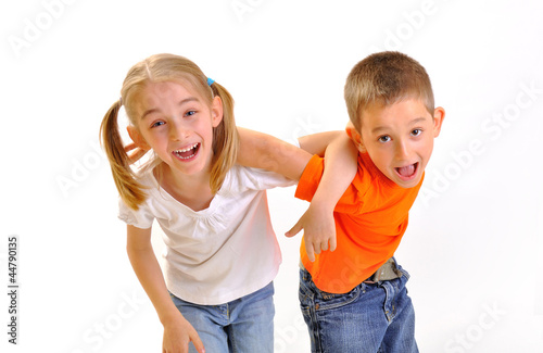 Two children, a boy and a girl scuffle, isolated on white