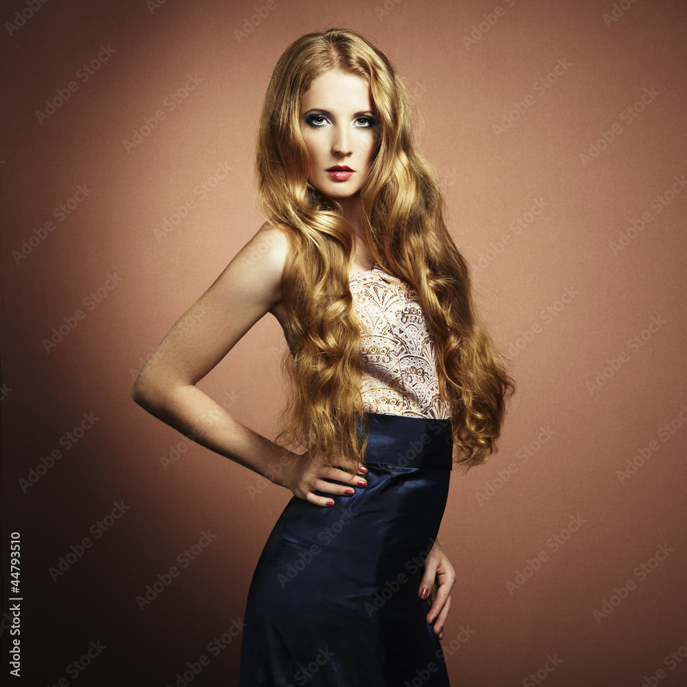 Fototapeta premium Portrait of beautiful woman with red hair in evening dress