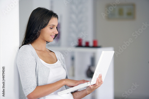 Woman using her laptop while standing up