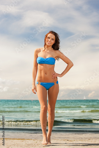 happy smiling woman walking on the beach