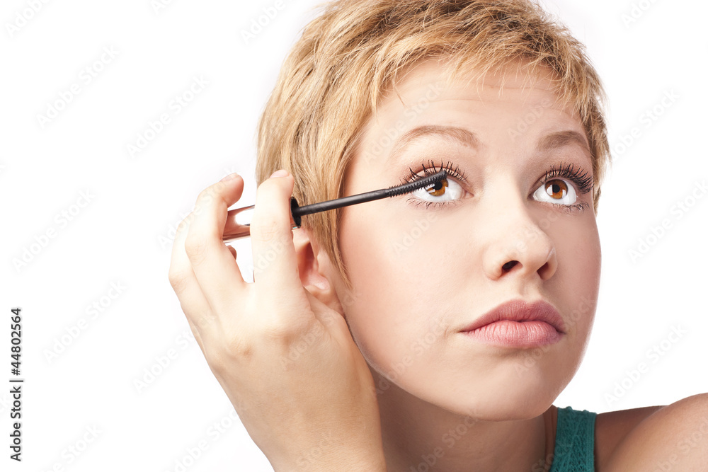 Woman paints the eyelashes