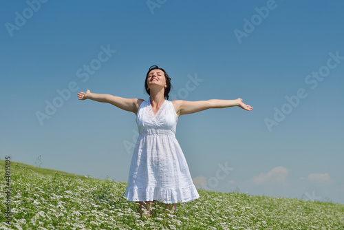 Young happy woman in green field