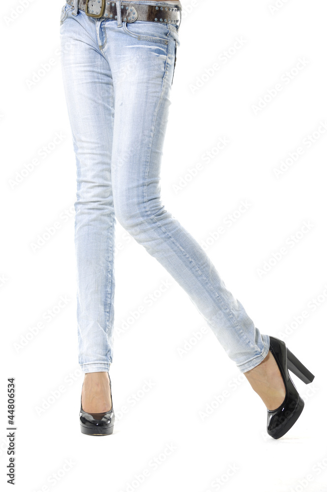 Female feet in jeans and in black shoes Female feet in jeans and in black shoes