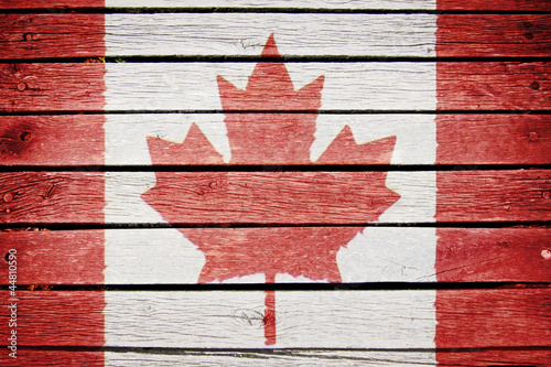 canadian flag painted on old wood plak background photo