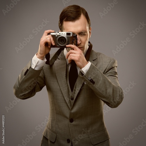 Businessman with a retro camera