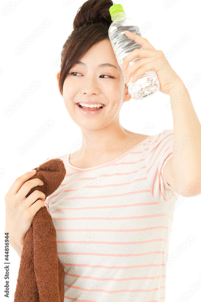 Beautiful young woman drinking water at workout. Portrait of asi Beautiful young woman drinking water at workout. Portrait of asi