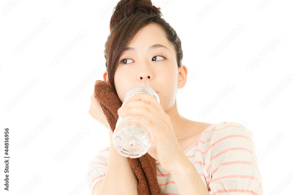 Beautiful young woman drinking water at workout Beautiful young woman drinking water at workout