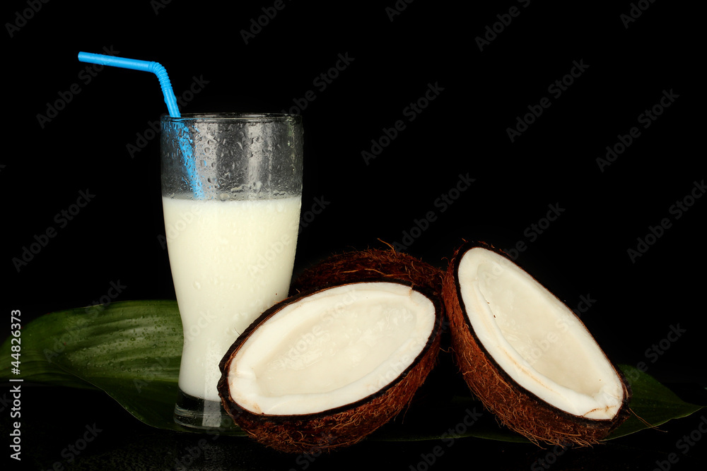 glass of coconut milk and coconuts isolated on black glass of coconut milk and coconuts isolated on black