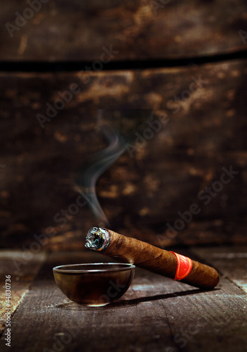 Burning luxury Cuban cigar photo