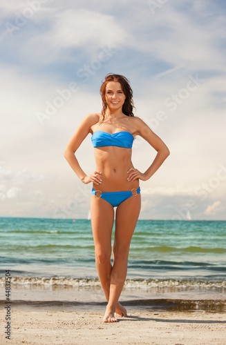 happy smiling woman walking on the beach