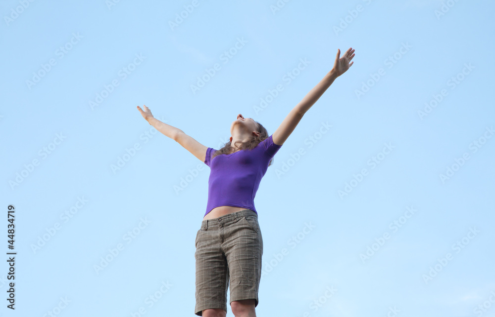 Young woman sitting with raised hand Young woman sitting with raised hand