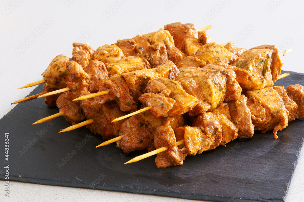 Meat brochettes on a slate tray