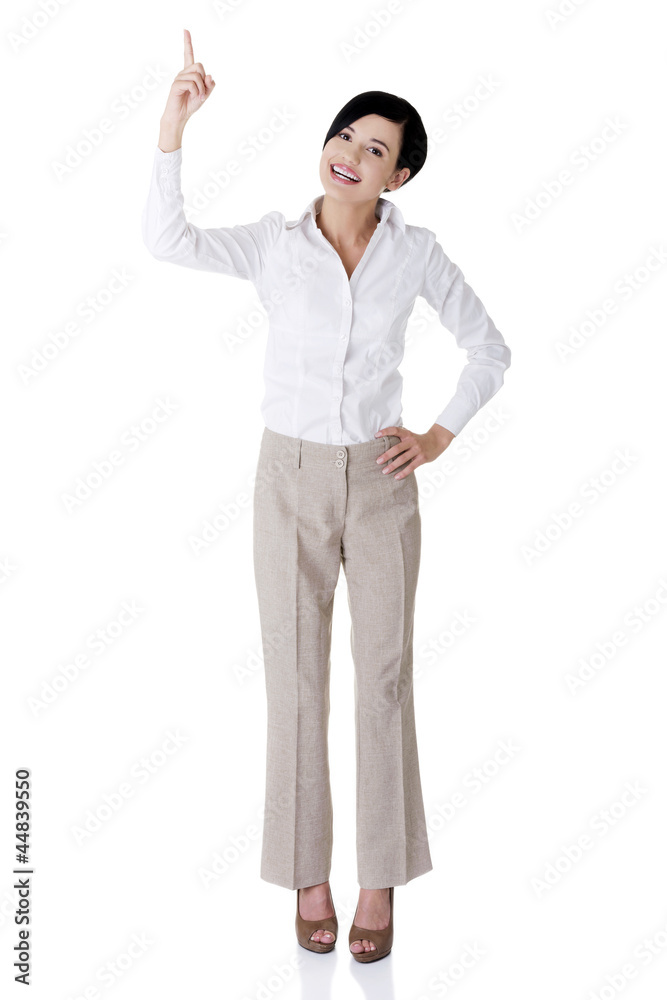 Beautiful business woman showing on copy space Beautiful business woman showing on copy space