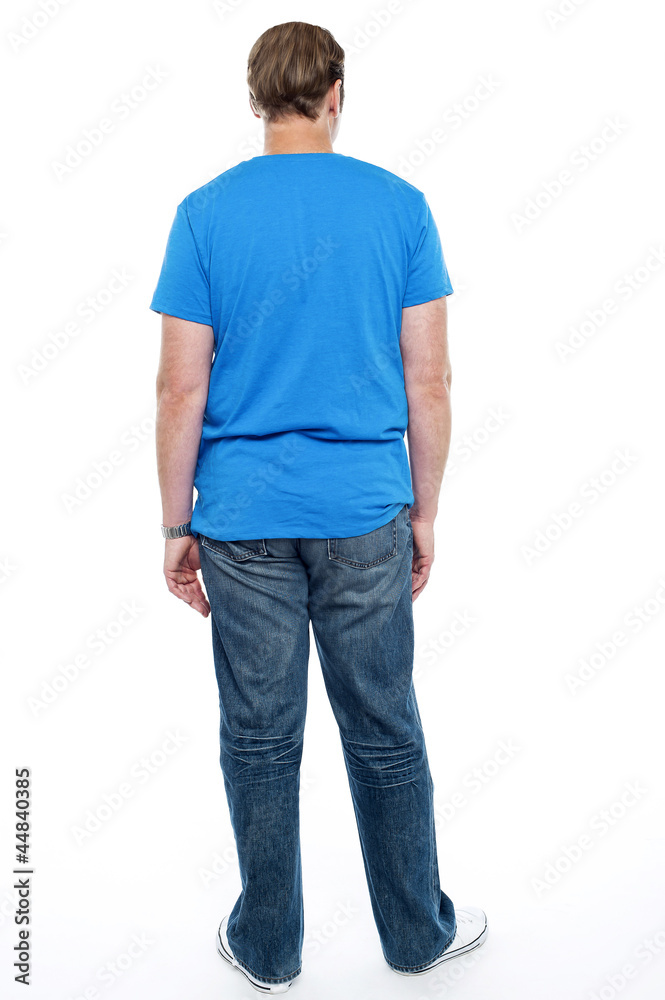 Rear view of casual young guy posing