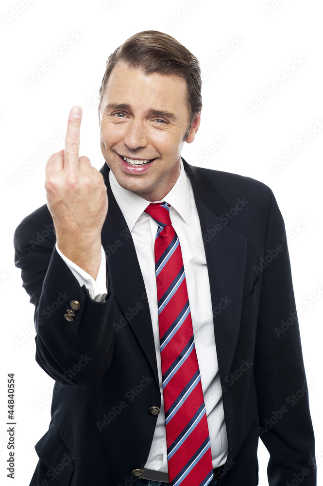 Displeased businessman showing middle finger politely Displeased businessman showing middle finger politely