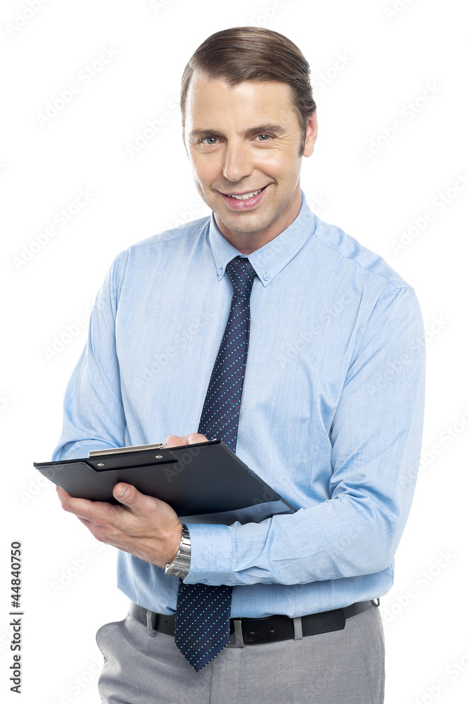 Smiling male secretary holding a clipboard