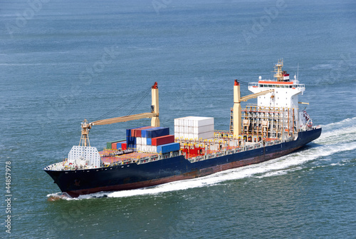 Cargo ship with containers moving
