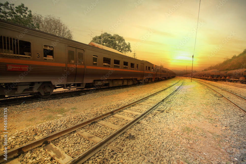 Fototapeta premium Train passing by in orange sunset