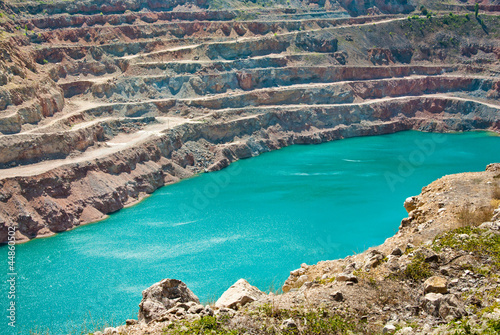 Open pit mine with lake photo