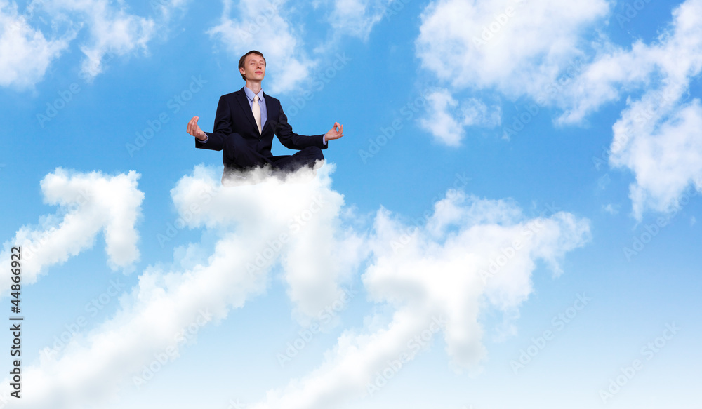 Businessman meditating sitting on the cloud Businessman meditating sitting on the cloud