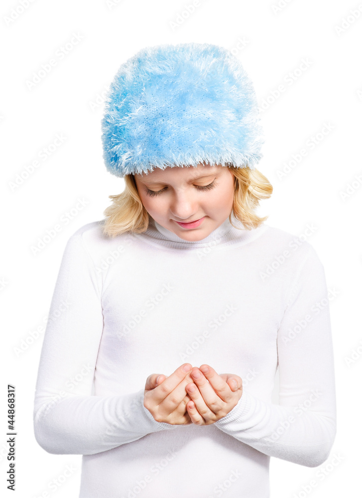 Cute preteen girl wearing winter outfit watching to her folding Cute preteen girl wearing winter outfit watching to her folding