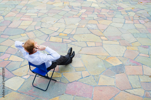 businessman sitting and calling the street